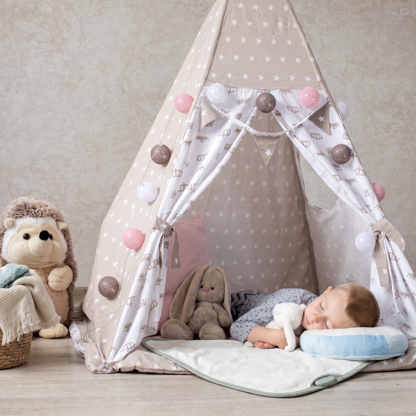 A toddler napping on the lillypad inside a play teepee at night, string lights glowing, a stuffed rabbit nearby